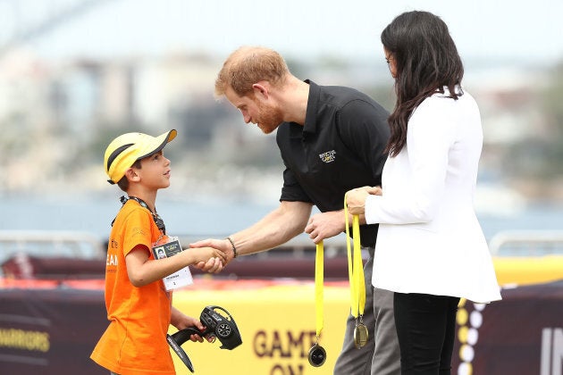 Harry and Meghan give medals to winners of the Young Drivers Challenge on Saturday.