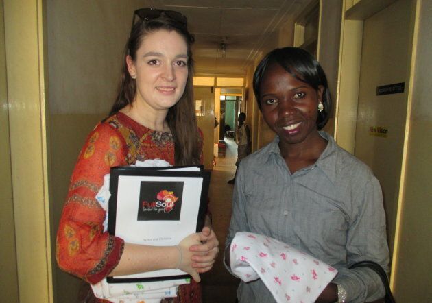 Hassan hands out baby blankets alongside FullSoul volunteer Asha Malingha at the Kawolo Hospital in Uganda in 2017. Each time a baby blanket is bought with one of FullSoul's partners, a baby blanket goes to a new mother in Uganda.