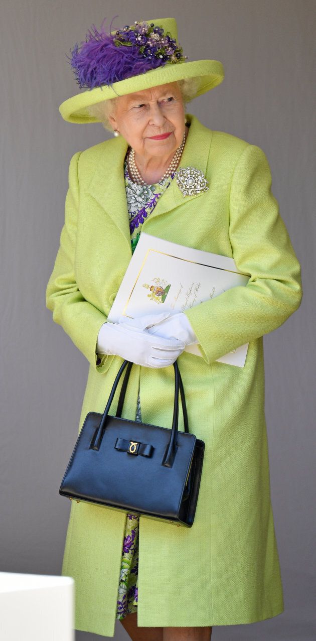 Queen Elizabeth looking quite regal in a lime green coat and hat at Markle and Prince Harry's wedding.