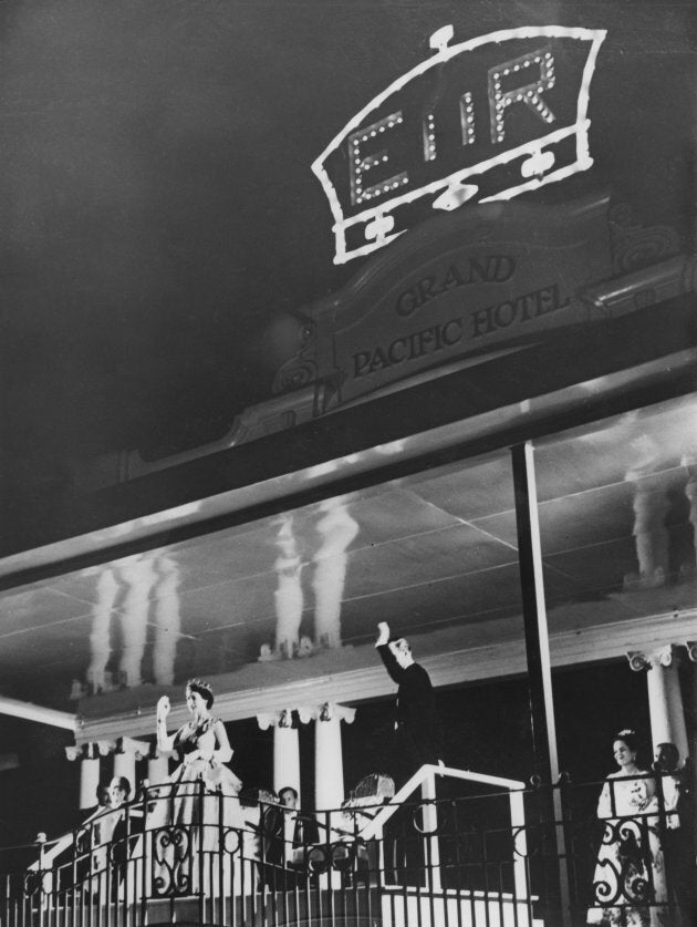 Queen Elizabeth II and Prince Philip wave to crowds from the balcony of the Grand Pacific Hotel in Suva, Fiji, on Dec. 28, 1953.