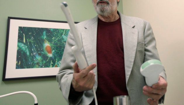 A doctor holds a transvaginal ultrasound device, left. The procedure is painful and often expensive.