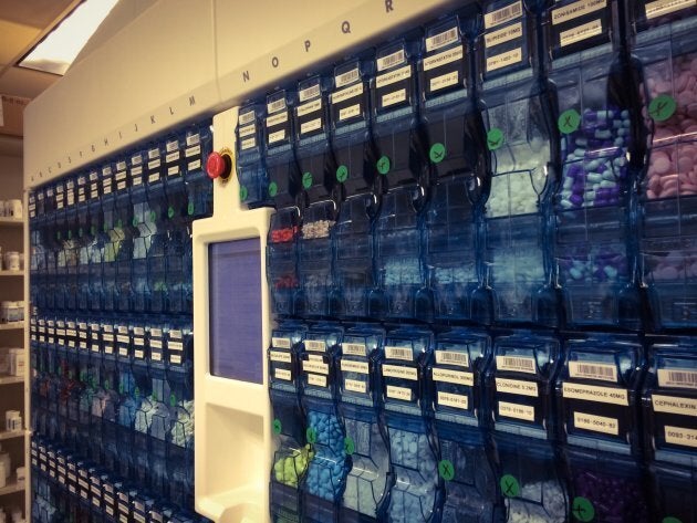 An automated pill dispensing station on an automated pharmacy assembly line.