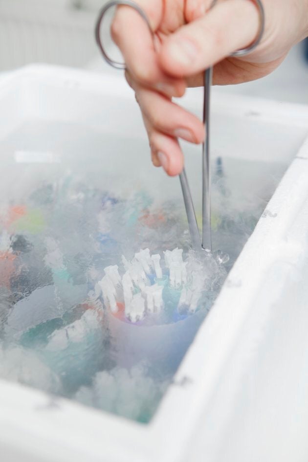 A sperm bank worker selects samples.