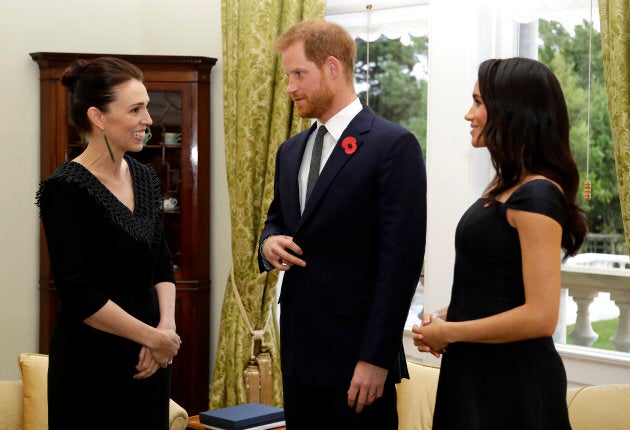 Jacinda Ardern speaks with Prince Harry and Meghan Markle at Government House in Wellington on Sunday.