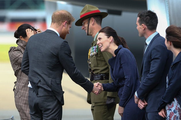 Prince Harry and Meghan Markle are welcomed by New Zealand's Prime Minister Jacinda Ardern (third from the right) as they arrive at the Wellington International Airport Military Terminal on Sunday.