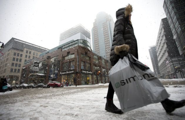 A pedestrian carries a La Maison Simons Inc. shopping bag in downtown Montreal on Dec. 24, 2016.