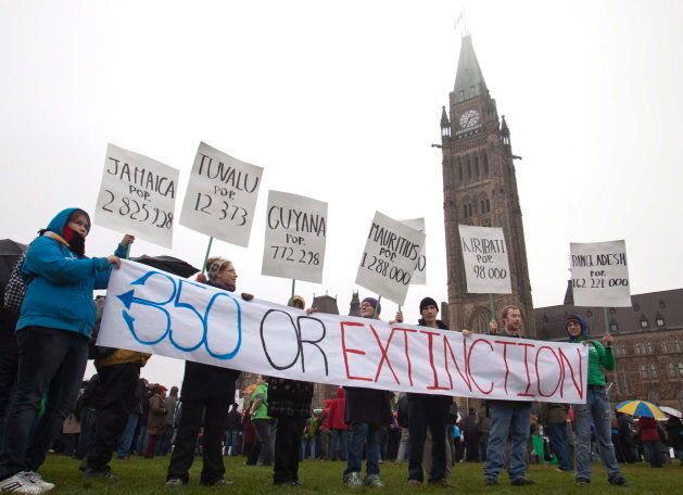 Protesters brave the rain during a call for climate change protest on Parliament Hill in Ottawa on Oct. 24, 2009.