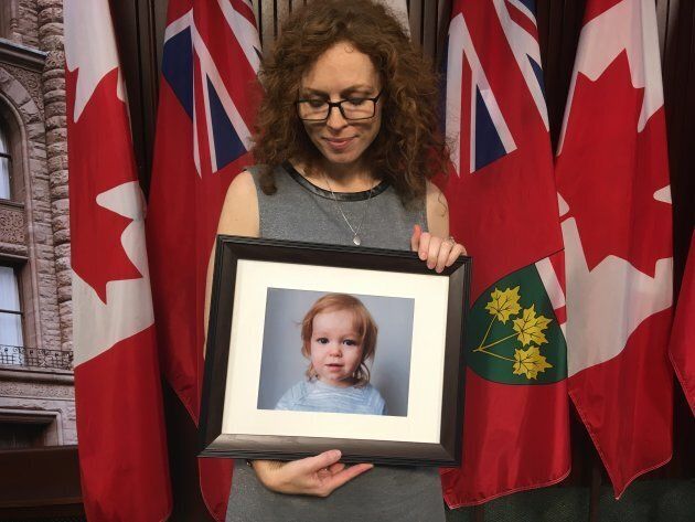 Jill Promoli holds a photo of her late son, Jude, after a press conference at Queen's Park on Oct. 30, 2018.