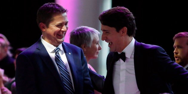 Prime Minister Justin Trudeau shares a laugh with Conservative Leader Andrew Scheer at the National Press Gallery Dinner in Gatineau, Que. on June 3, 2017.