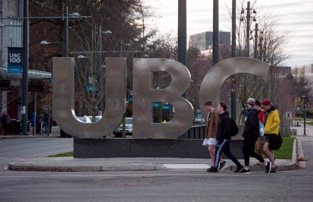 People walk past large letters spelling out UBC at the University of British Columbia in Vancouver on...
