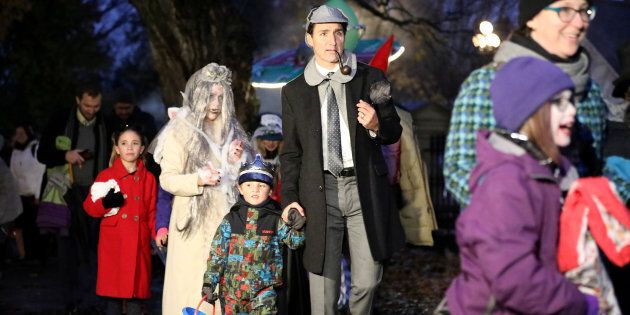 Prime Minister Justin Trudeau walks with his son Hadrien while participating in Halloween festivities with his family at Rideau Hall in Ottawa on Wednesday.