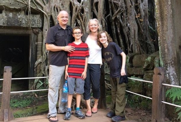 The Kistormas pose for a family photo at Ta Prohm in Cambodia.