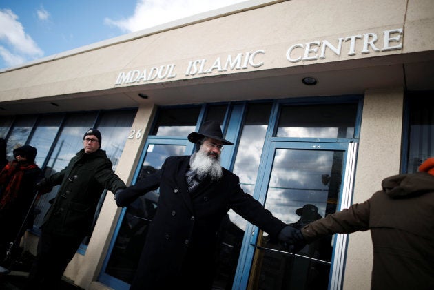 People from the Holy Blossom Temple Synagogue and the Fairlawn United Church form a "Ring of Peace" outside The Imdadul Islamic Centre, during prayers, to show solidarity in condemning the deadly shooting at the Quebec Islamic Cultural Centre, in Toronto on Feb. 3, 2017.