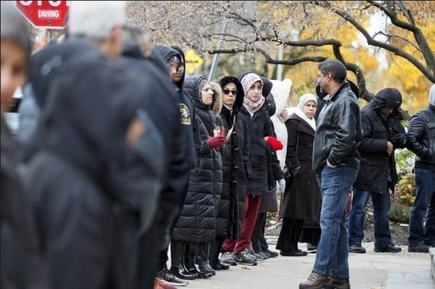 Demonstrators of various faiths, including members of the Islamic Institute of Toronto, gather at Beth Sholom in York, Ont. on Nov. 3, 2018.