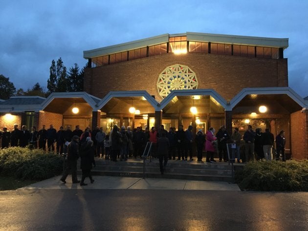 Members of Embrace Islamic Society form a Ring of Peace around Temple Emanuel in North York, Ont. on Nov. 2, 2018.