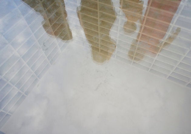 The book burning memorial at Bebelplatz in Berlin takes the form of empty white bookshelves beneath a sheet of glass.