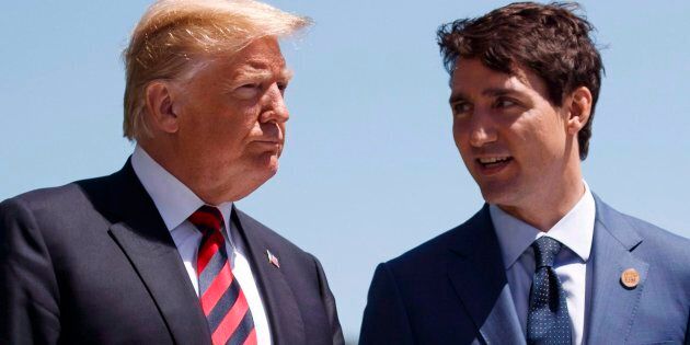 U.S. President Donald Trump talks with Prime Minister Justin Trudeau during a G7 Summit welcome ceremony in Charlevoix, Que. on June 8, 2018.