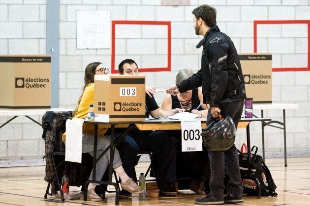 A man casts his ballot at a polling station in the provincial elections on October 1, 2018 in Montreal, Quebec. (Photo by MARTIN OUELLET-DIOTTE / AFP) (Photo credit should read MARTIN OUELLET-DIOTTE/AFP/Getty Images)