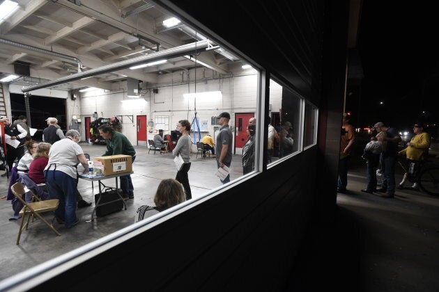 Voters wait in line to cast ballots at a polling station in Modesto, Calif. Voter turnout in many states surged during this year's midterms.