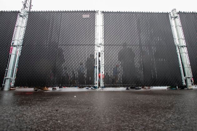 Refugees who crossed the Canada/U.S. border wait in a temporary detention centre in Blackpool, Que. on Aug. 5, 2017.