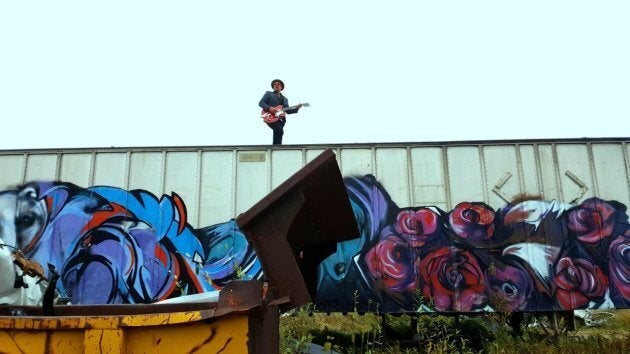 Adrian Sutherland on top of a boxcar during Midnight Shine's music video shoot for "I Need Angels."