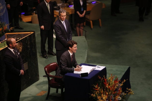 Prime Minister Justin Trudeau signing the Paris Accord.