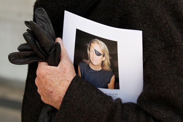 A man holds a sign honouring Sunday Times journalist Marie Colvin, who died in Syria in 2012.