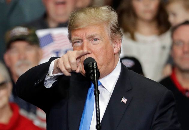 U.S. President Donald Trump points to the media during a campaign rally on Oct. 26, 2018 in Charlotte, N.C. and says they are "the enemy of the people."