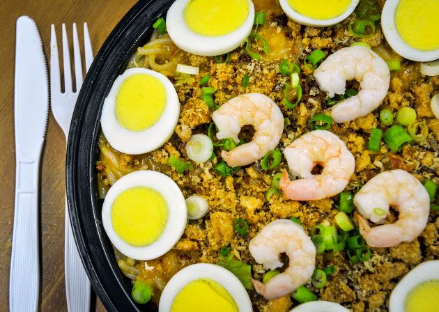 Pancit palabok, a noodle dish with egg, shrimp, garlic, pork rinds, etc.