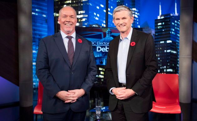 B.C. Premier John Horgan (L) and Liberal Leader Andrew Wilkinson smile for the cameras at a debate on the province's electoral system on Nov. 8, 2018.