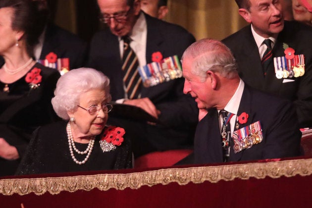 Queen Elizabeth II speaks with Prince Charles.