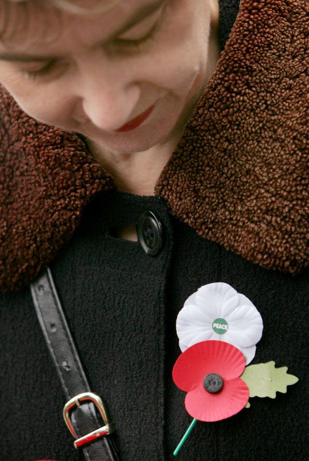 A woman wears a red poppy of remembrance and a white poppy of peace on Armistice Day at the Cenotaph in central London on Nov. 11, 2006.