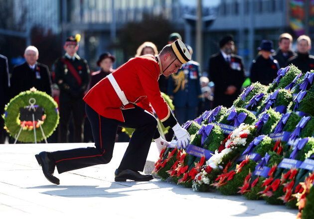 A soldier places a predominantly red wreath during Remembrance Day ceremonies at the National War Memorial in Ottawa on Nov. 11, 2017.
