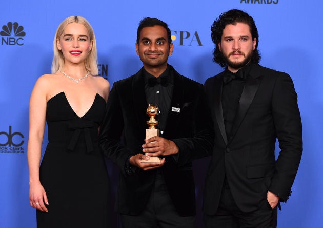 Aziz Ansari poses with his Golden Globe for Best Performance by an Actor in a Television Series (Musical or Comedy) for "Master of None" at the 75th annual Golden Globe Awards at the Beverly Hilton Hotel on Jan. 7, 2018, along with "Game of Thrones" stars Emilia Clarke and Kit Harington.