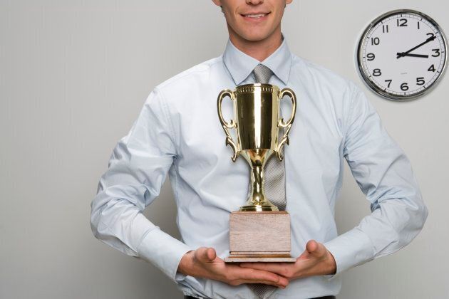 Businessman holding trophy