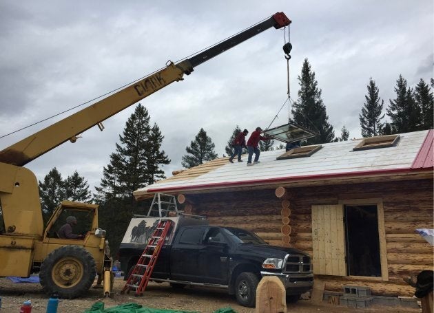 The 50-year-old Clark crane, a beast of a machine that Grandpa Tony kinda sorta accidentally bought, works to lift up the cabin's skylights.