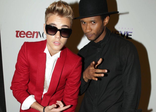 Justin Bieber poses with Usher Raymond at the premiere of Open Road's "Justin Bieber's Believe" on Wednesday, Dec. 18, 2013 in Los Angeles.