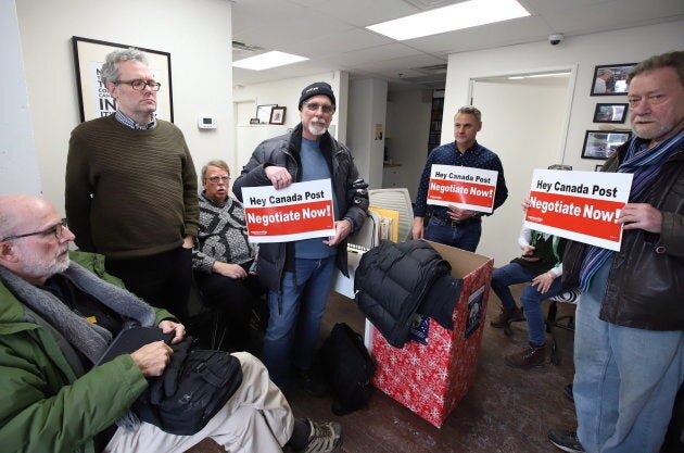 Members of the Canadian Union of Postal Workers occupy Minister of Environment Catherine McKenna's community office in Ottawa on Nov. 23, 2018.