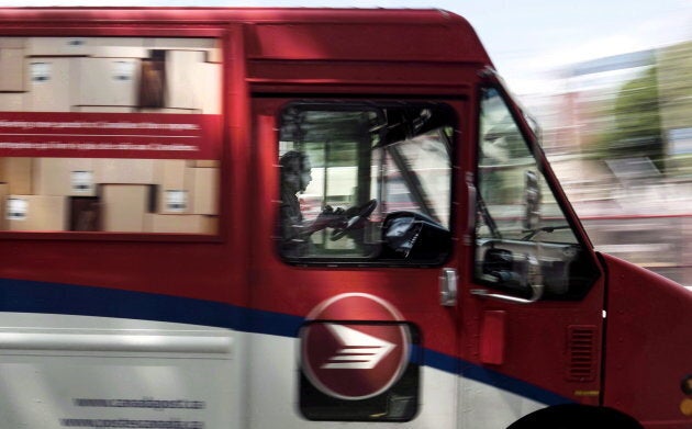 A Canada Post employee drives a mail truck through downtown Halifax on July 6, 2016.