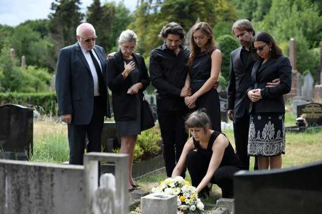 Family laying flowers on the grave