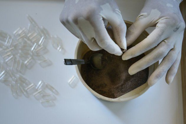 A midwife places dehydrated human placenta into capsules in Washington, D.C.