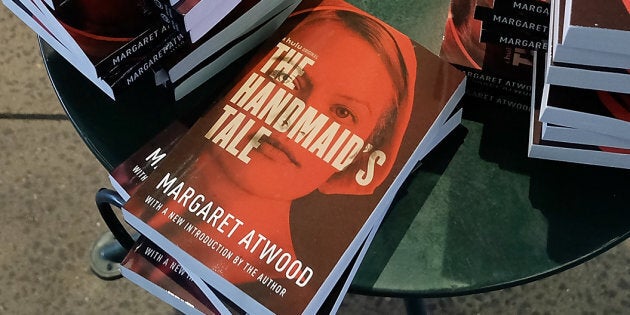 Organizers arrange copies of Margaret Atwood's book 'The Handmaid's Tale' during the Interactive 'The Handmaid's Tale' Art Installation Opening at The High Line on April 26, 2017 in New York City.