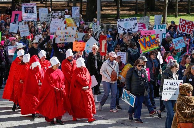 Women angered by the bitter fight over a US Supreme Court nominee and what they called the 'anti-woman agenda' of the Trump administration headed into the streets of Chicago on Saturday in a display of political might. Dressing in the iconic red "handmaid's" outfit has become a recognizable protest of the treatment of women.