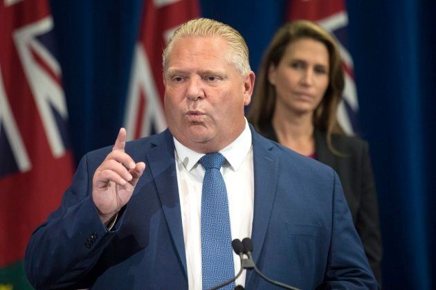 Ontario Premier Doug Ford speaks as then Ontario Attorney General Caroline Mulroney looks on during a press announcement at the Queens Park Legislature in Toronto on Aug. 9, 2018.
