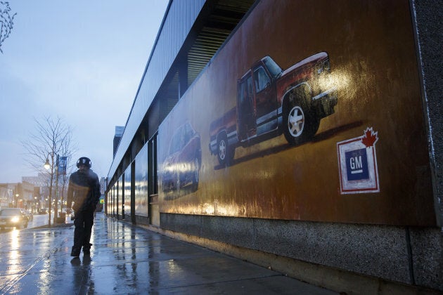 A pedestrian walks past a General Motors mural in downtown Oshawa, Ont. on Monday, Nov. 26, 2018.