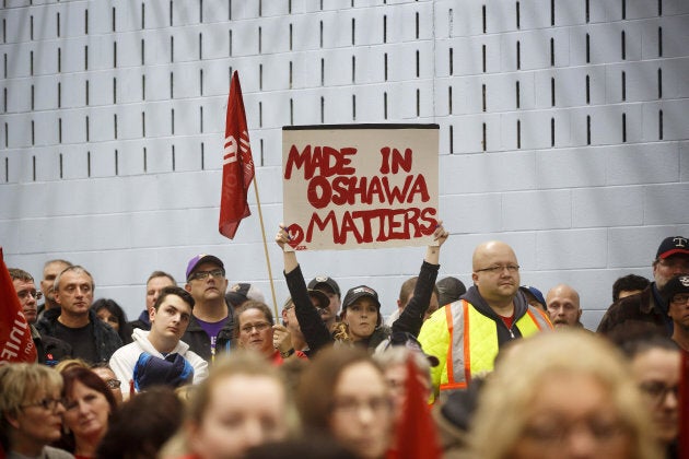 A General Motors worker holds a sign reading 'Made In Oshawa Matters' during an information meeting at Unifor Union Hall in Oshawa, Ont. on Monday, Nov. 26, 2018.