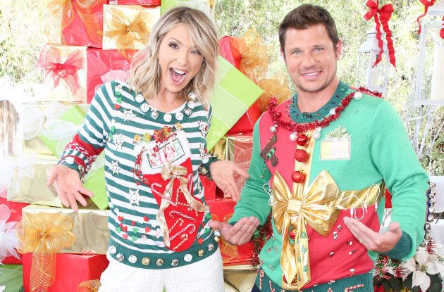 TV hosts Debbie Matenopoulos and Nick Lachey visit Hallmark's 'Christmas In July' wearing ugly Christmas sweaters.