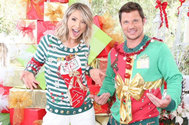 TV hosts Debbie Matenopoulos and Nick Lachey visit Hallmark's 'Christmas In July' wearing ugly Christmas sweaters.