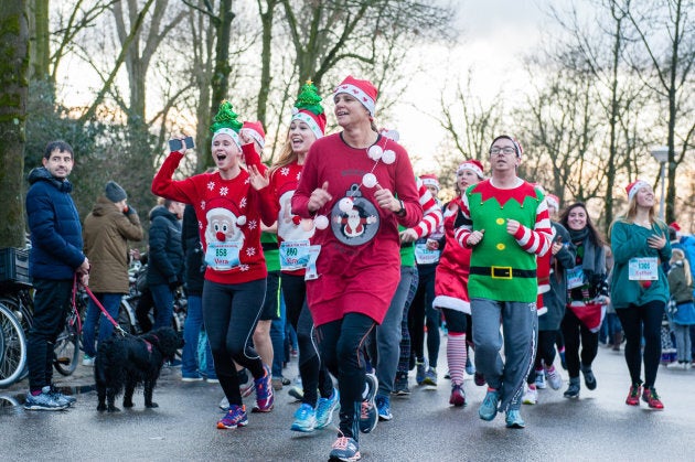 People take part in an Ugly Christmas Sweater Run on Dec. 16, 2017 in Amsterdam.