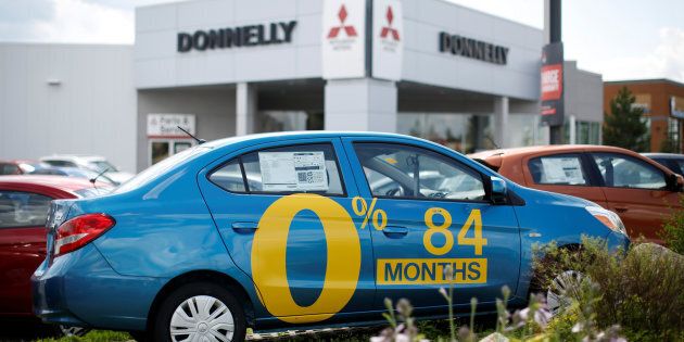 A car advertises an 84-month (seven-year) loan term at a Mitsubishi dealership in Ottawa, Ont., July 18, 2017. Hot on the heels of GM Canada's announcement it is shutting its long-running Oshawa assembly plant comes the news that Canadian auto sales have hit the skids.